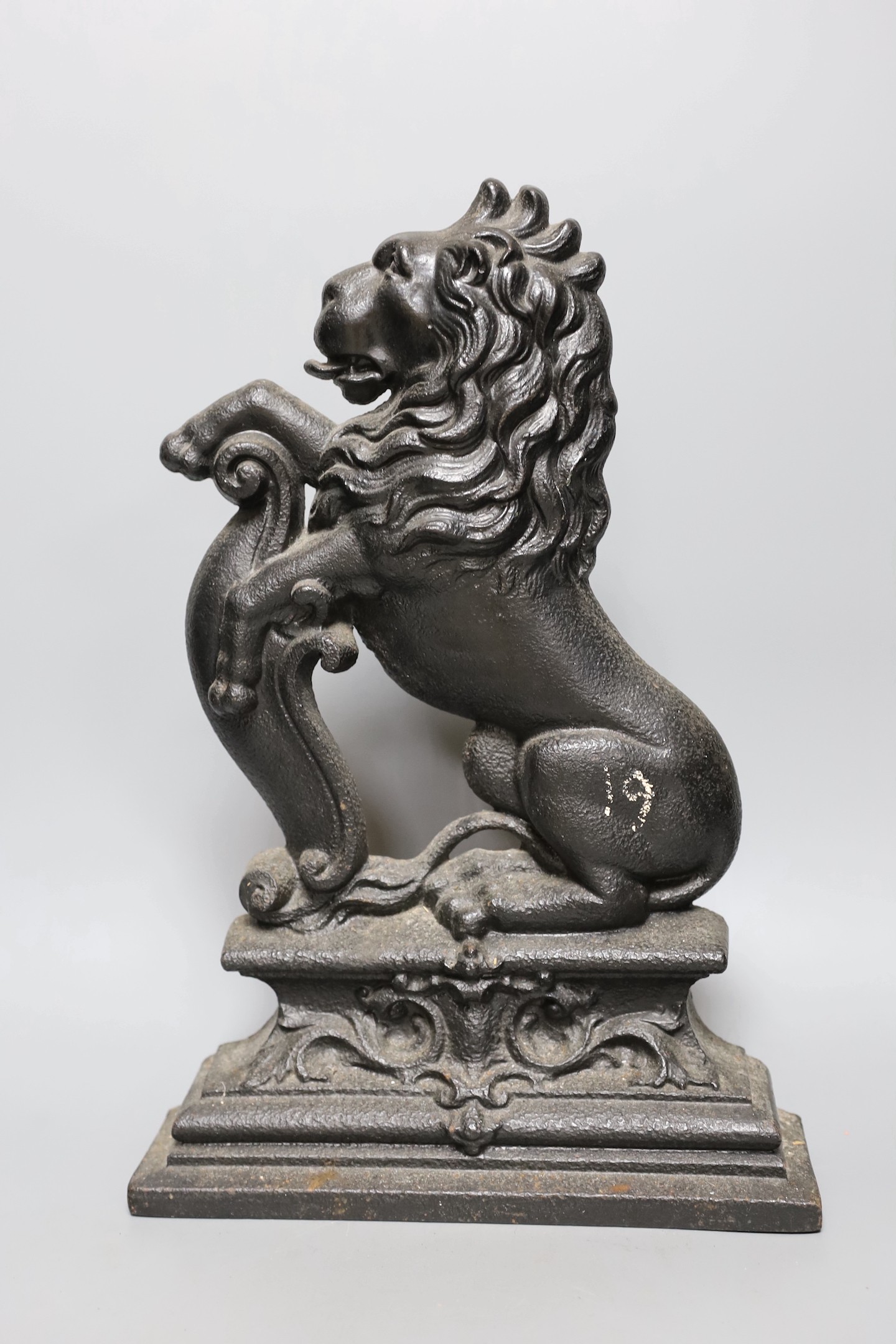 Four cast iron ‘lion’ door stops, 39cm